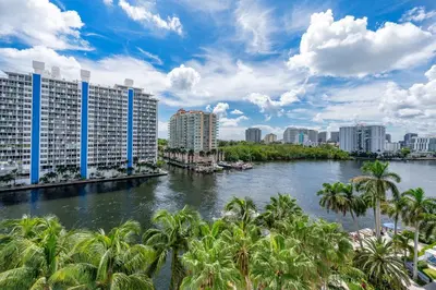 a view of a river with palm trees and buildings at Amazing Intracoastal Views - Walk to the Beach! in Fort Lauderdale