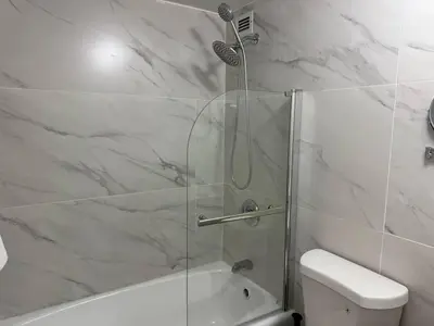 a bathroom with a shower with a glass door at 1701 - Studio Ocean Front Free Parking Pool in Miami Beach