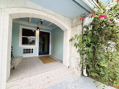 an entrance to a house with an archway and flowers at Urban Oasis Studio, Miami near Coral Gables #5 in Miami