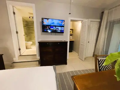 a living room with a flat screen tv on a wall at Urban Oasis Studio, Miami near Coral Gables #5 in Miami