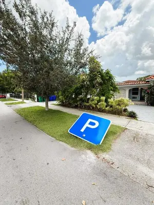 a blue parking sign on the side of a road at Urban Oasis Studio, Miami near Coral Gables #5 in Miami