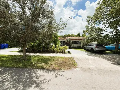 a house with cars parked in front of a driveway at Urban Oasis Studio, Miami near Coral Gables #5 in Miami
