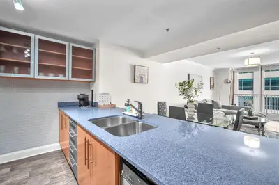 a kitchen with a sink and a living room at Lux condo on 25floor in Brickell in Miami