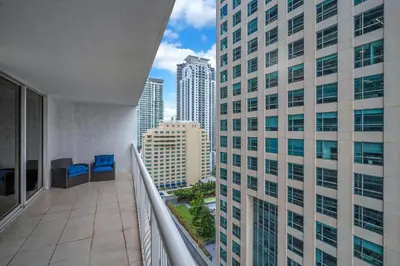 a balcony with blue chairs and a view of a city at Lux condo on 25floor in Brickell in Miami
