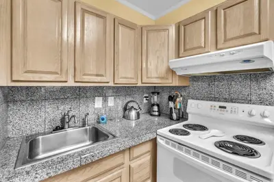 a kitchen with a white stove and a sink at Blue Reverie - Downtown Cottage in Fort Lauderdale