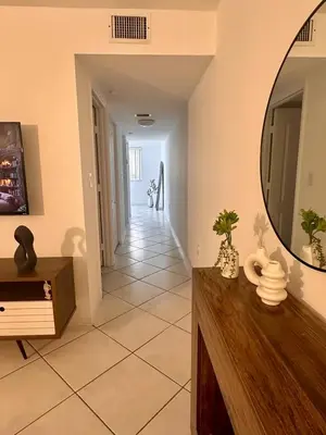 a living room with a mirror and a tile floor at Beautiful 2brm condo w free parking fast WiFi in Lindgren Acres