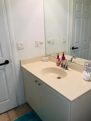 a bathroom with a sink and a mirror at Miami Fort Lauderdale Vacation Rooms in Miramar