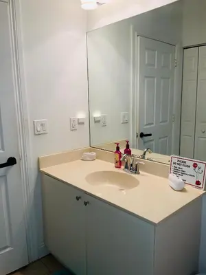 a bathroom with a sink and a mirror at Miami Fort Lauderdale Vacation Rooms in Miramar