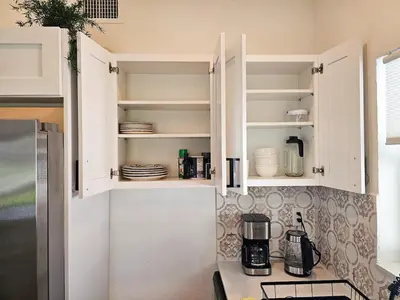 a kitchen with white cabinets and a refrigerator at Modern 3BR Home Near Holycross Hospital in Fort Lauderdale