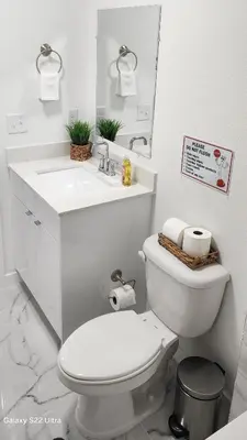 a white bathroom with a toilet and a sink at Magic City IN THE HEART OF MIAMI in Miami
