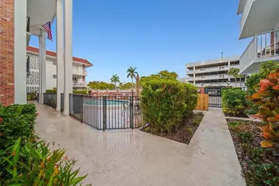 a walkway in front of a building with a gate at Luxe Escape 2BR Fort Lauderdale in Fort Lauderdale