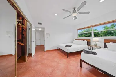a bedroom with two beds and a ceiling fan at Luxe Escape 2BR Fort Lauderdale in Fort Lauderdale