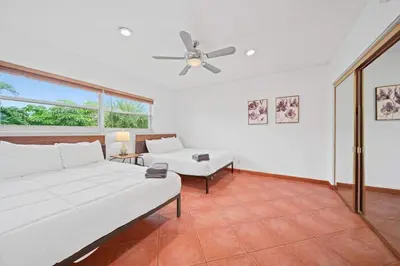 a living room with a couch and a ceiling fan at Luxe Escape 2BR Fort Lauderdale in Fort Lauderdale