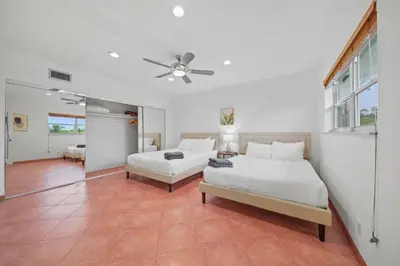 a bedroom with two beds and a ceiling fan at Luxe Escape 2BR Fort Lauderdale in Fort Lauderdale
