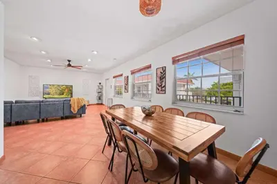 a dining room with a table and chairs and a couch at Luxe Escape 2BR Fort Lauderdale in Fort Lauderdale