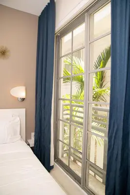 a bedroom with a bed and a large window at Spacious Studio Rooftop Pool & Bar with Ocean View in Miami Beach