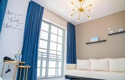 a living room with a couch and a window at Spacious Studio Rooftop Pool & Bar with Ocean View in Miami Beach