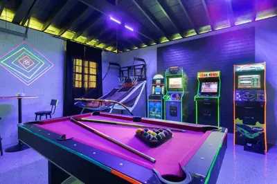 a pool table in a room with arcade machines at Cozy 4BR Pool Villa Near The Beach with Arcades in Fort Lauderdale