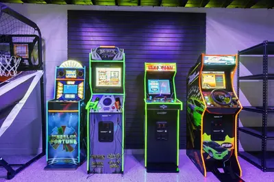 three video game machines sitting next to each other at Cozy 4BR Pool Villa Near The Beach with Arcades in Fort Lauderdale