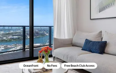 a living room with a couch and a large window at MVR - 2BR Luxury Stay in the Heart of Miami in Miami