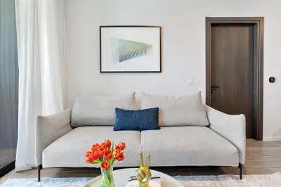 a living room with a couch and a vase of flowers at MVR - 2BR Luxury Stay in the Heart of Miami in Miami