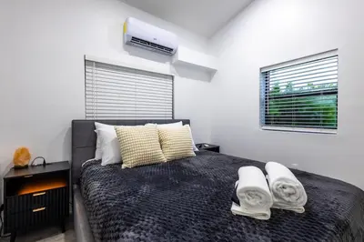 a bedroom with a large bed with towels on it at The Side Villa in Miami