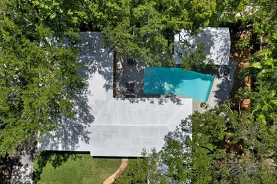 an overhead view of a pool in a garden with trees at Memory Lane Cozy Home with Pool Lush South Miami in Miami