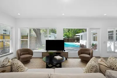 a living room with a couch and chairs and a tv at Memory Lane Cozy Home with Pool Lush South Miami in Miami