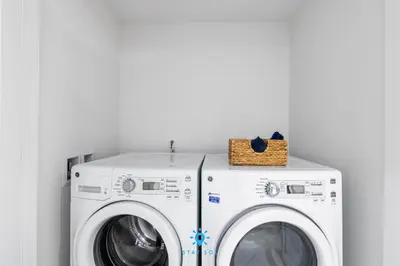 a white washer and dryer in a laundry room at Luxury 2BR Apt With Ocean View Pool & Amenities in Hollywood