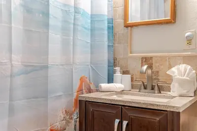 a bathroom with a sink and a shower curtain at Oceanfront Bliss Cozy 1BR by Beach Free Parking in Hollywood