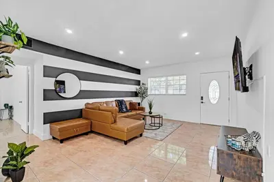 a living room with a couch and a table at Miami Luxury Home Close to Beach & Aventura Mall in Biscayne Park