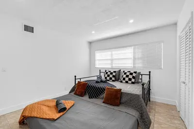 a bedroom with a large bed and a window at Miami Luxury Home Close to Beach & Aventura Mall in Biscayne Park