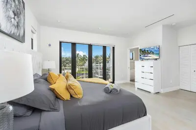 a bedroom with a large bed with yellow pillows at Villa Costa in Hollywood