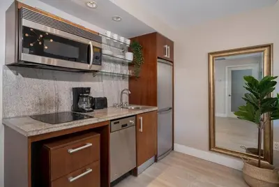a kitchen with a sink and a microwave at Ocean Dr 1BR Apt with Rooftop Pool 93 Walk Score in Miami Beach