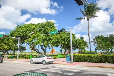 a car parked at an intersection with a street sign at Ocean Drive Retreat - Beach Access & Rooftop Pool in Miami Beach