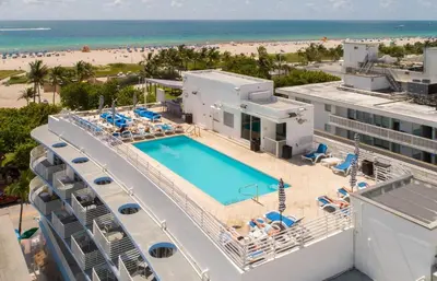 an aerial view of a resort with a swimming pool and the beach at Ocean Drive Retreat - Beach Access & Rooftop Pool in Miami Beach