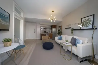 a living room with a white couch and a table at Ocean Drive Retreat - Beach Access & Rooftop Pool in Miami Beach
