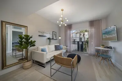 a living room with a white couch and a table at Ocean Drive Retreat - Beach Access & Rooftop Pool in Miami Beach