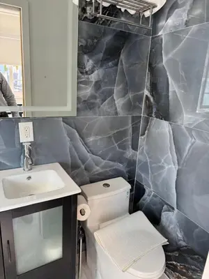 a bathroom with a white toilet and a sink at In the heart of little Havana 5 in Miami