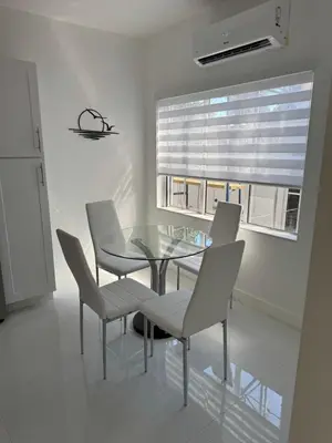 a dining room with a table and chairs and a window at In the heart of little Havana 5 in Miami
