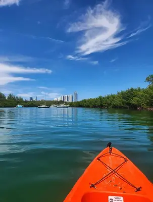 an orange kayak in the water on a river at Lovely 2-Bedroom Oceanfront condo in Sunny Isles Beach