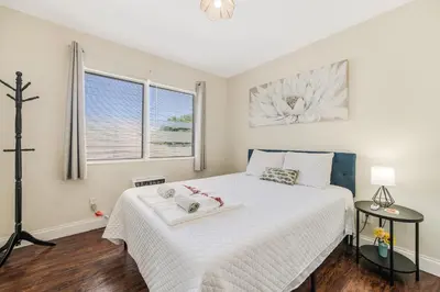 a bedroom with a white bed and a window at Cozy 1BR Apt Steps from Calle 8 & Mins to Brickell in Miami