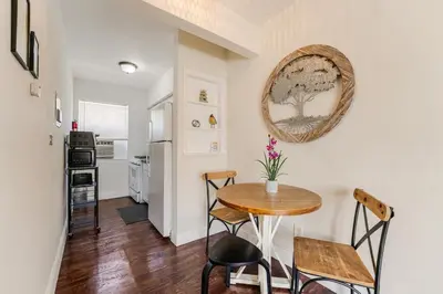 a kitchen and dining room with a table and chairs at Cozy 1BR Apt Steps from Calle 8 & Mins to Brickell in Miami