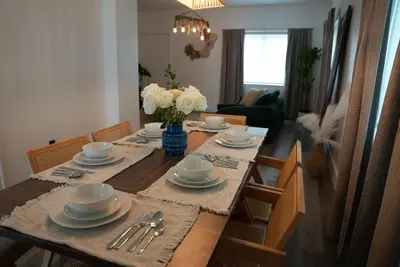 a dining room table with plates and silverware on it at Near Brickell, Beach & Port 10min, Style & Comfort in Miami