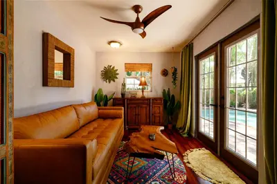 a living room with a couch and a ceiling fan at Hacienda de Amor - Heated pool - Hot Tub - Firepit in Fort Lauderdale