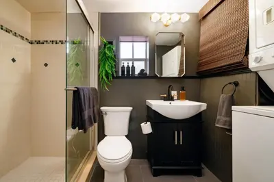 a bathroom with a toilet and a sink and a shower at Hacienda de Amor - Heated pool - Hot Tub - Firepit in Fort Lauderdale