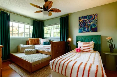 a bedroom with a bed and a couch at Hacienda de Amor - Heated pool - Hot Tub - Firepit in Fort Lauderdale