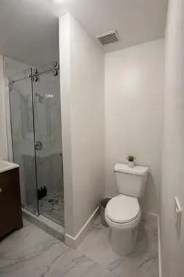 a white bathroom with a toilet and a shower at Villa Miami Lakes 2 in Hialeah