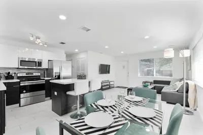 a kitchen and living room with a table and chairs at Modern 2BR Near Wynwood and Design District in Miami