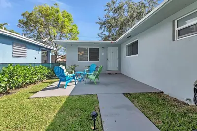 a patio with chairs and a table in front of a house at Modern 2BR Near Wynwood and Design District in Miami